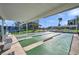Shuffleboard court with shade, seating, and palm trees offering outdoor activities at 7600 Sun Island S Dr # 407, South Pasadena, FL 33707