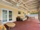 Enclosed porch featuring vaulted ceilings, ceiling fans, comfortable furniture, and a peaceful outdoor view at 7712 40Th N Ter, St Petersburg, FL 33709