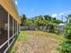 Fenced backyard with lush greenery, a storage shed, and space for outdoor activities off the screened porch at 7712 40Th N Ter, St Petersburg, FL 33709