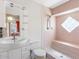Bright bathroom with a walk-in shower featuring a diamond-patterned glass block window at 7712 40Th N Ter, St Petersburg, FL 33709