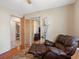 Bedroom featuring a comfortable recliner and mirrored closet with a sliding door at 7712 40Th N Ter, St Petersburg, FL 33709