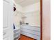 Walk-in closet with built-in shelving and drawers provides ample storage space at 7712 40Th N Ter, St Petersburg, FL 33709