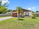 A cozy single-story home featuring a two-car garage, fresh lawn, and a young palm tree in the front yard at 7712 40Th N Ter, St Petersburg, FL 33709