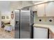 Kitchen featuring a stainless steel refrigerator and sleek countertop next to the dining and living area at 7712 40Th N Ter, St Petersburg, FL 33709