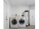 Functional laundry room with a washer, dryer, and water heater, and storage cabinets at 7712 40Th N Ter, St Petersburg, FL 33709