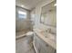 Renovated bathroom features new vanity, a large mirror and a walk-in shower with modern tile at 7831 Red Run Dr, Port Richey, FL 34668