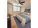 Bedroom with wood-look floors, ceiling fan, ample natural light, and a serene aesthetic at 7831 Red Run Dr, Port Richey, FL 34668