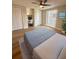 Cozy bedroom featuring neutral tones, closet, built-in desk, and a ceiling fan for added comfort at 7831 Red Run Dr, Port Richey, FL 34668