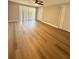 Light and airy bedroom featuring wood-look floors, a ceiling fan, and a large window at 7831 Red Run Dr, Port Richey, FL 34668