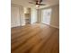 Bedroom boasts wood-look floors, a ceiling fan, natural light, and built-in storage cabinets at 7831 Red Run Dr, Port Richey, FL 34668