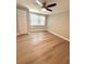 Clean bedroom with wood-look floors, a ceiling fan, natural light and closet at 7831 Red Run Dr, Port Richey, FL 34668
