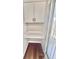 A built-in desk and cabinetry provides convenient storage and workspace, complemented by wood-look flooring at 7831 Red Run Dr, Port Richey, FL 34668