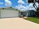 Charming one-story home featuring a freshly painted exterior, new roof, landscaped yard, and a two car garage at 7831 Red Run Dr, Port Richey, FL 34668