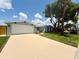 Charming one-story home featuring a freshly painted exterior, new roof, landscaped yard, and a two car garage at 7831 Red Run Dr, Port Richey, FL 34668