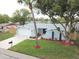Charming one-story home showcasing a freshly painted exterior, new roof, landscaped yard, and an attached two-car garage at 7831 Red Run Dr, Port Richey, FL 34668