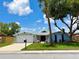 Charming one-story home featuring a freshly painted exterior, new roof, landscaped yard, and a two car garage at 7831 Red Run Dr, Port Richey, FL 34668
