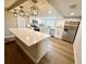 Spacious kitchen with stainless steel appliances, white cabinets, and a large center island at 7831 Red Run Dr, Port Richey, FL 34668
