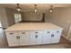 Kitchen featuring a large center island, modern lighting, and white cabinetry at 7831 Red Run Dr, Port Richey, FL 34668