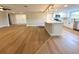 Open-concept kitchen features white cabinets, stainless steel appliances, and a spacious island with quartz countertops at 7831 Red Run Dr, Port Richey, FL 34668