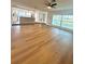 Open-concept living room showcasing wood floors and abundant natural light at 7831 Red Run Dr, Port Richey, FL 34668
