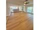 Spacious living room with wood floors, seamlessly connecting to the modern kitchen at 7831 Red Run Dr, Port Richey, FL 34668