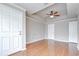Spacious bedroom with hardwood floors, ceiling fan, and multiple doors at 800 S Dakota Ave # 429, Tampa, FL 33606
