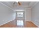 Spacious bedroom with hardwood floors, ceiling fan, and ample natural light at 800 S Dakota Ave # 429, Tampa, FL 33606