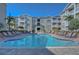 Expansive community pool with lounge seating, a gazebo, and well-maintained landscaping in Hyde Park Walk at 800 S Dakota Ave # 429, Tampa, FL 33606
