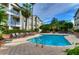 Inviting community pool surrounded by lounge chairs and lush landscaping, perfect for relaxation and recreation at 800 S Dakota Ave # 429, Tampa, FL 33606