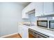 An eat-in kitchen with a stainless steel sink, faucet, and appliances at 800 S Dakota Ave # 429, Tampa, FL 33606
