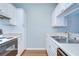 Bright kitchen featuring white cabinets, stainless steel sink, and modern fixtures at 800 S Dakota Ave # 429, Tampa, FL 33606