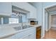 An eat-in kitchen with a stainless steel sink, faucet, and appliances at 800 S Dakota Ave # 429, Tampa, FL 33606