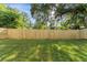 Spacious backyard featuring a lush green lawn and a new wooden privacy fence at 8112 N 10Th St, Tampa, FL 33604