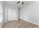 Bright bedroom with modern ceiling fan and wood-look flooring with door to closet and hall at 8112 N 10Th St, Tampa, FL 33604