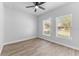 Bright bedroom with modern ceiling fan, two windows and wood-look flooring at 8112 N 10Th St, Tampa, FL 33604