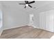Bedroom featuring a ceiling fan, wood floors, and access to the bathroom at 8112 N 10Th St, Tampa, FL 33604