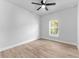 This bedroom has a modern ceiling fan, wood-look flooring and a sunlit window at 8112 N 10Th St, Tampa, FL 33604
