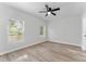 Bedroom featuring two windows, a ceiling fan, and wood floors at 8112 N 10Th St, Tampa, FL 33604