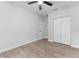 This bright bedroom features a ceiling fan, wood-look flooring and a closet at 8112 N 10Th St, Tampa, FL 33604