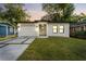 Charming single-story home boasts a freshly painted exterior, a new roof, and a well-maintained yard at 8112 N 10Th St, Tampa, FL 33604