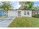 Charming single-story home boasts a freshly painted exterior, a new roof, and a well-maintained yard at 8112 N 10Th St, Tampa, FL 33604