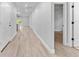 A spacious hallway featuring durable wood-look floors and a neutral color palette at 8112 N 10Th St, Tampa, FL 33604