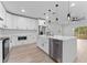 Bright kitchen features white cabinets, stainless steel appliances, and a large island with a sink at 8112 N 10Th St, Tampa, FL 33604