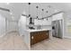 Open-concept kitchen with stainless steel appliances, a large island, and updated finishes at 8112 N 10Th St, Tampa, FL 33604