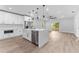 Modern kitchen features an island with quartz countertops and stainless steel appliances at 8112 N 10Th St, Tampa, FL 33604