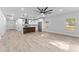 Open-concept living room and kitchen features hardwood floors, stainless steel appliances, and lots of space at 8112 N 10Th St, Tampa, FL 33604