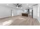 Open-concept living room and kitchen features hardwood floors, stainless steel appliances, and lots of space at 8112 N 10Th St, Tampa, FL 33604