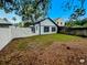 Backyard featuring lush grass and modern white fence at 8209 Volusia Pl, Tampa, FL 33637