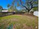 Large back yard featuring a wooden fence and lush grass at 8209 Volusia Pl, Tampa, FL 33637