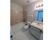 Cozy bathroom featuring a shower-tub combo and ample lighting at 8209 Volusia Pl, Tampa, FL 33637